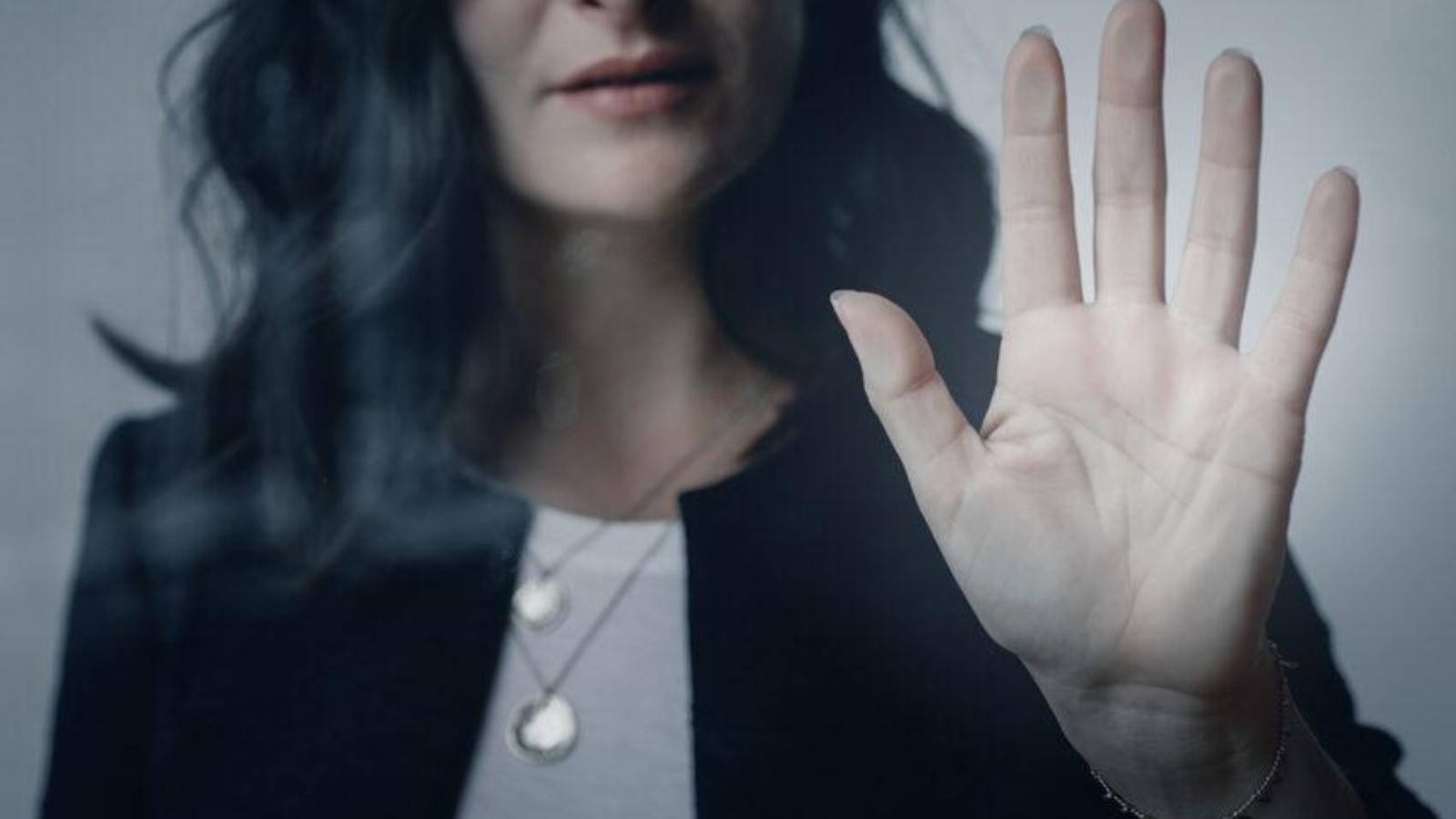 Woman with a beautiful hand touching the window